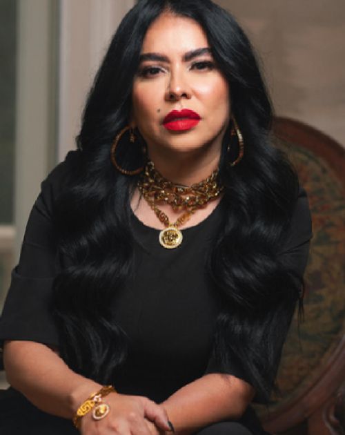 A professional headshot of Lynn Oliver, a woman with long, straight brown hair and bangs.
