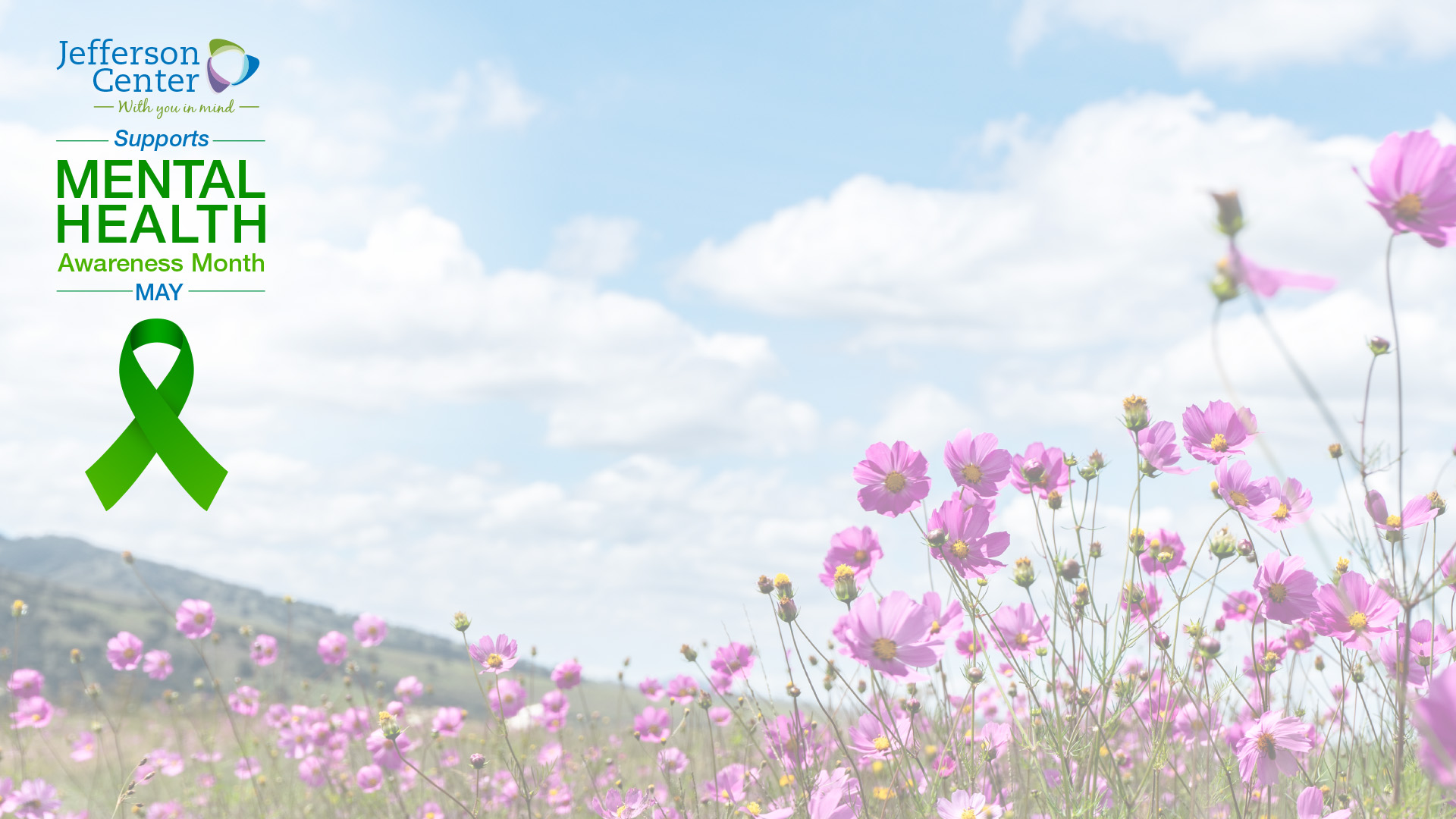 A digital background for virtual meetings. The background is a serene photograph of a field of pink wildflowers under a blue sky with clouds. On the left side is the Jefferson Center logo and text that reads, "Supports Mental Health Awareness Month - MAY," along with a green awareness ribbon.