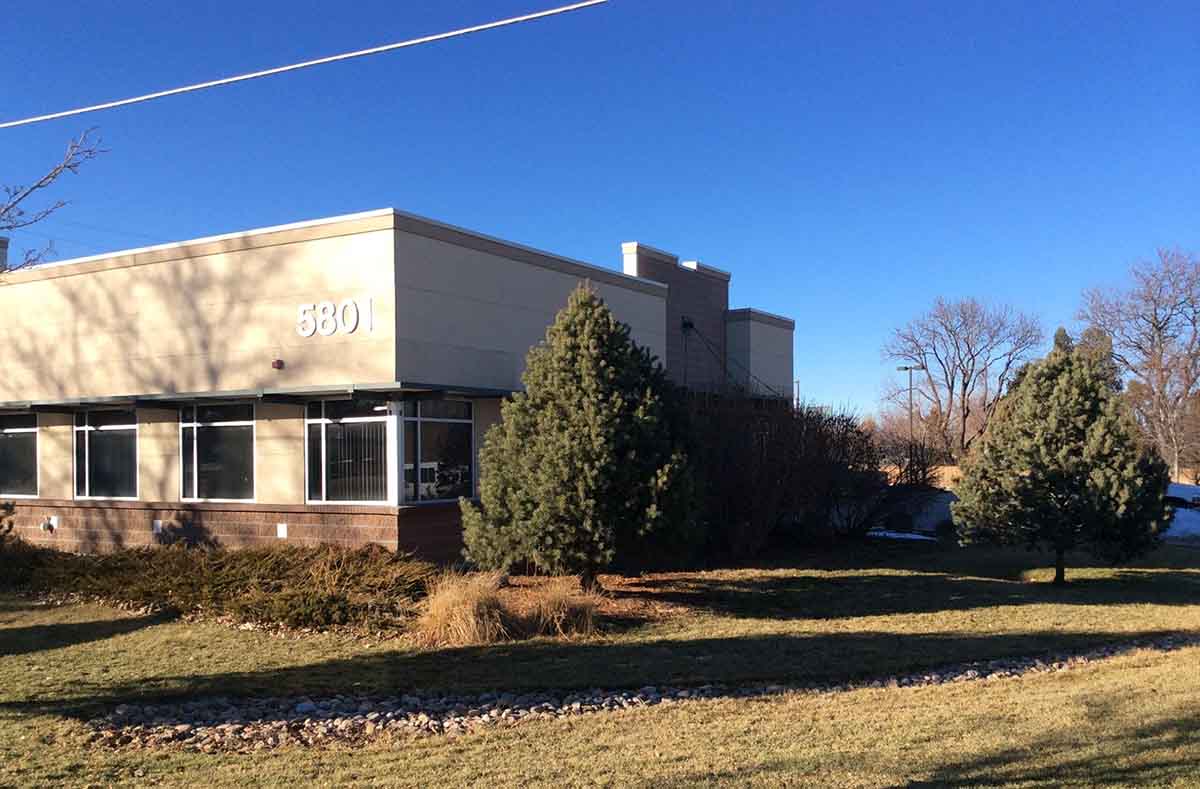 The exterior of the alameda office building with the address "5301" on its tan-colored facade. 